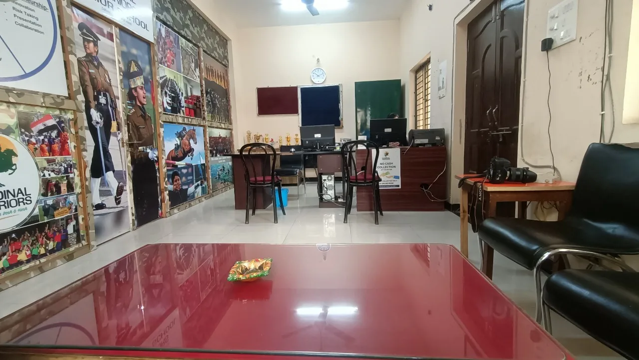 The reception and front office at Cardinal Warriors, with computers, trophies and camouflage-framed cadet and equestrian posters lining the wall.
