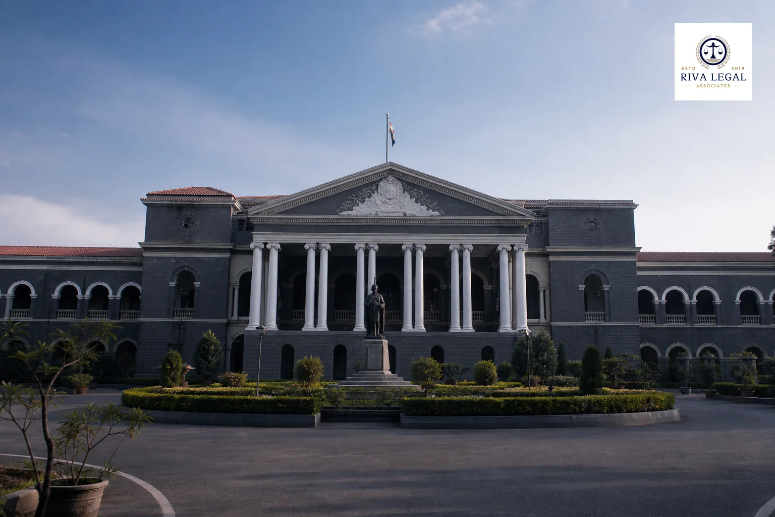 Exterior or interior of an Indian court building conveying civil litigation for IP disputes. photorealistic photo of the exterior facade of an Indian High Court style building with classical columns, a clear afternoon sky, shot from a