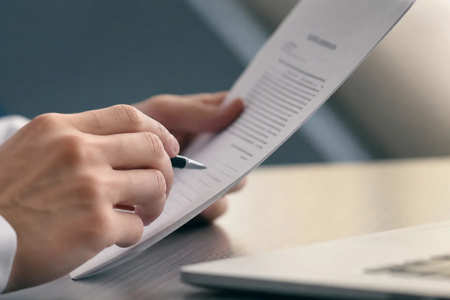 Person carefully reviewing a legal retainer agreement before signing