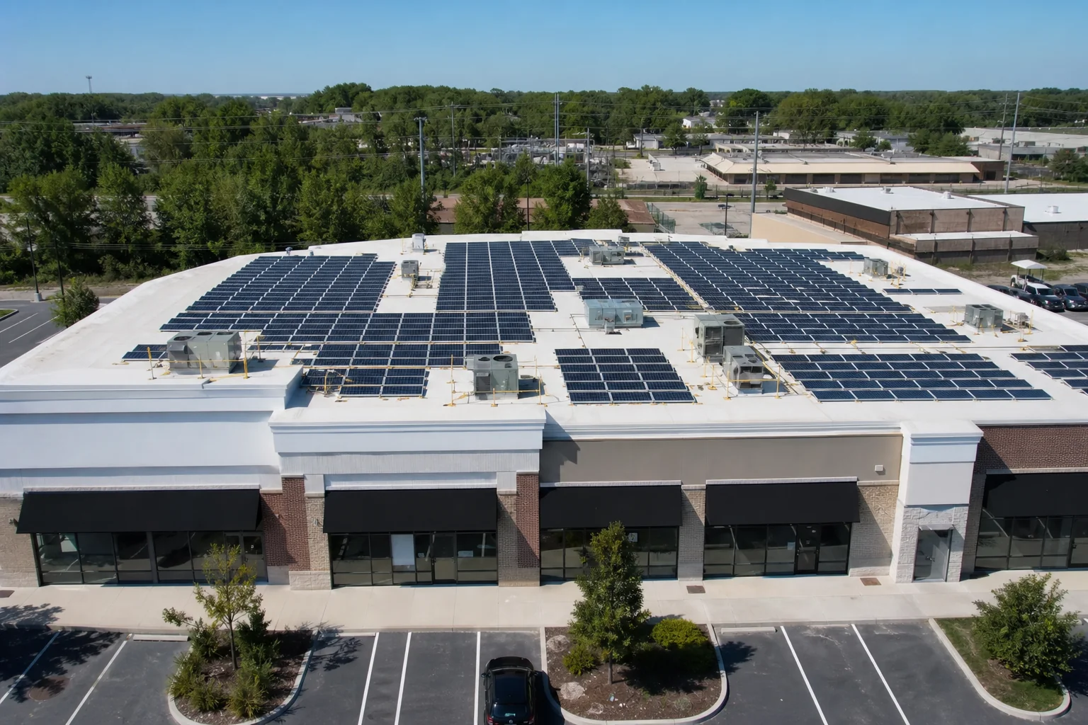 Commercial rooftop solar array on a small strip-mall style leased building. photorealistic photo of a flat commercial rooftop with rows of solar panels, small strip retail building below with visible tenant storefronts, aerial drone