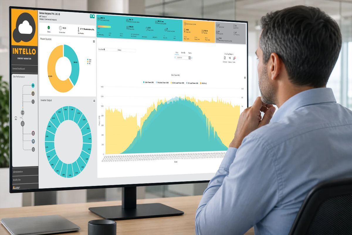 Engineer viewing a solar monitoring dashboard on a laptop showing DG and PV data together. Photorealistic photo of an engineer sitting at a desk in an office in India, viewing a laptop screen displaying a solar and generator monitoring