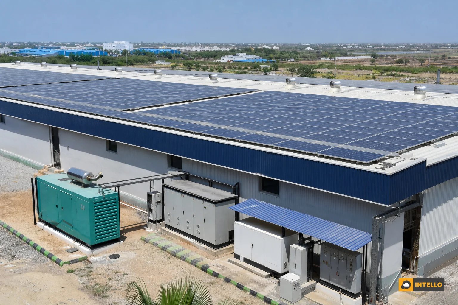 Rooftop solar installation on a commercial building with a diesel generator unit visible nearby, representing a hybrid solar-diesel power setup. Photorealistic photo of a large commercial rooftop solar panel installation in India under