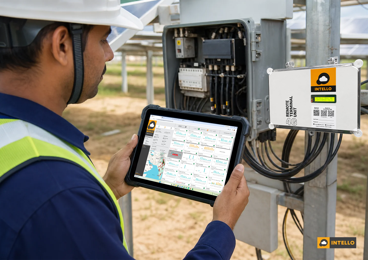 Photorealistic photo of a solar O&M engineer in India holding a rugged tablet displaying a solar performance monitoring dashboard with graphs and alert icons, standing near an outdoor combiner box and remote terminal unit at a solar