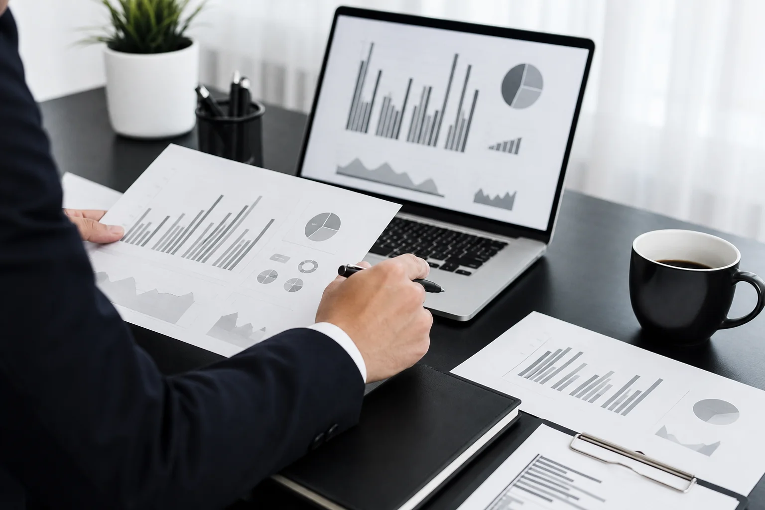 A checklist or vetting process visualized through a founder reviewing documents and a laptop with charts. Photorealistic photo of a businessperson's hands reviewing printed documents and a laptop showing abstract bar charts, on a black and