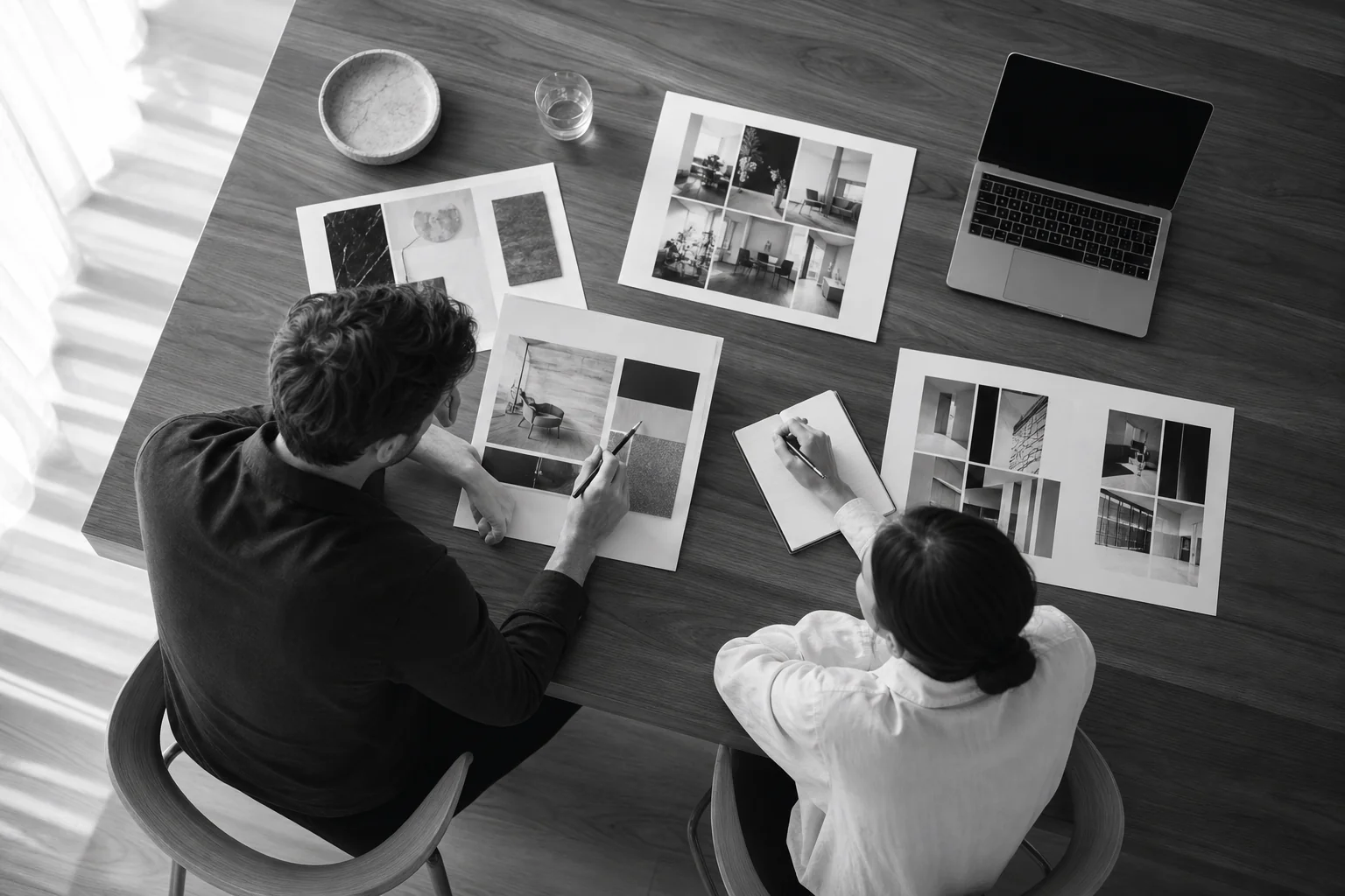 Team comparing multiple UI UX design agency portfolios and scorecard notes on a table during evaluation