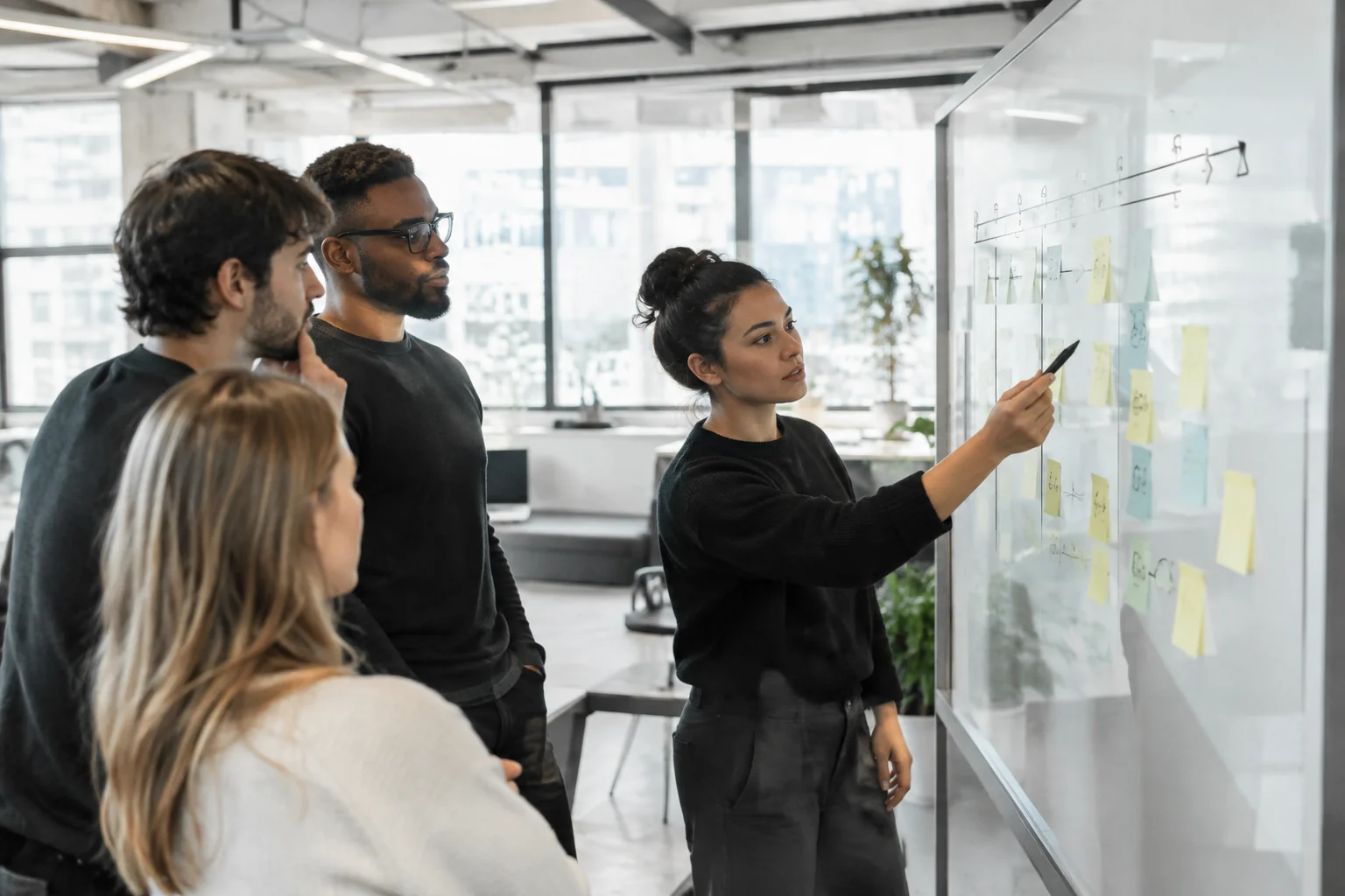 A small cross-functional startup and development team reviewing a sprint timeline on a whiteboard. photorealistic: a small diverse team of three developers and a founder gathered around a glass whiteboard covered with a week-by-week sprint