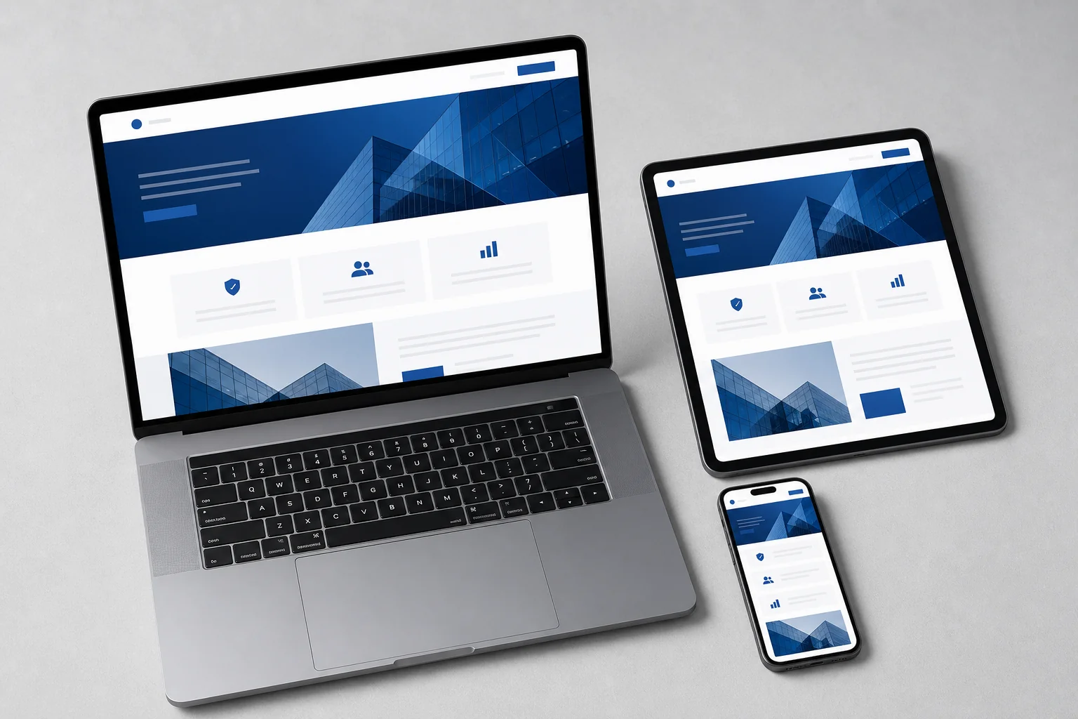 Clean B2B website interface displayed across laptop, tablet, and smartphone showing responsive design with professional blue-and-white colour scheme