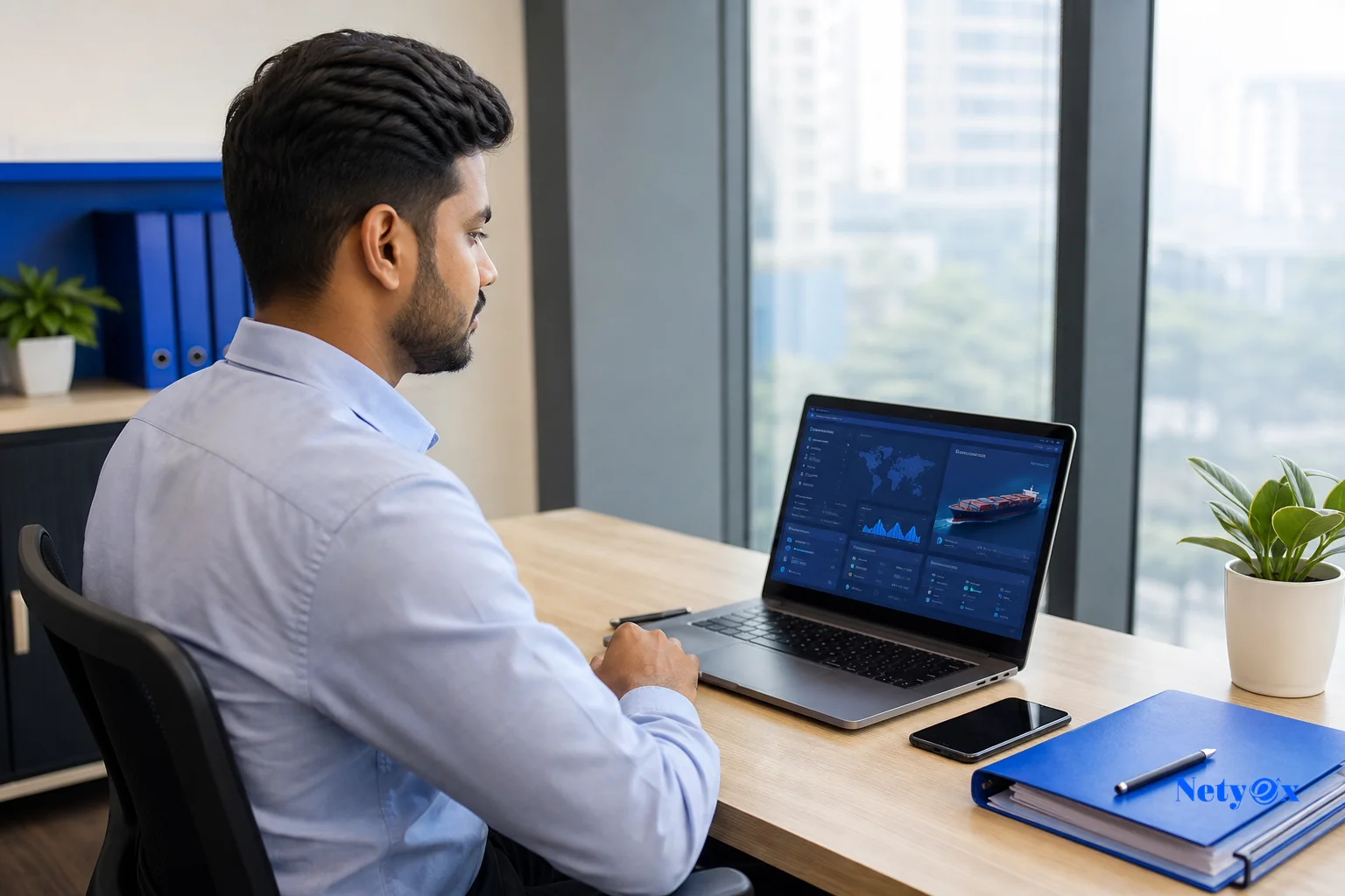A sourcing specialist coordinating with a buyer remotely via a laptop showing shipment tracking, representing a dedicated sourcing partner managing documentation. Photorealistic photo of a professional Indian sourcing specialist at a modern