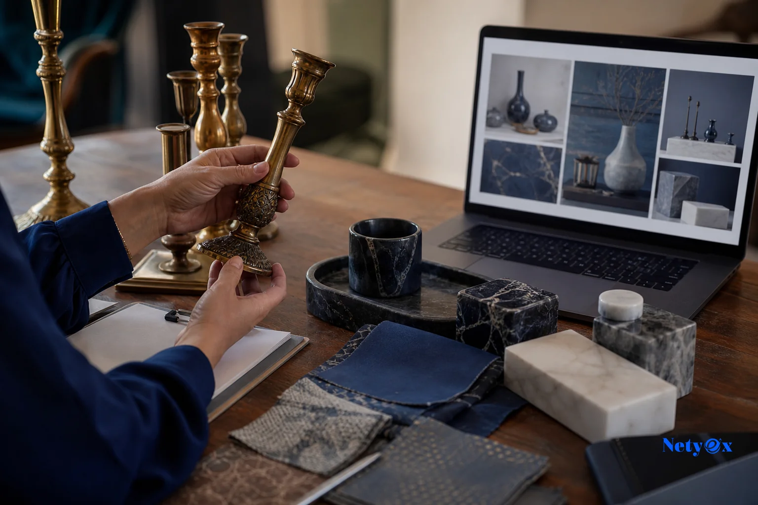 Close-up of an event decor buyer reviewing brass and marble wedding decor samples with a spec sheet. Photorealistic photo of a professional buyer's hands reviewing ornate brass candle holders, marble decor pieces, and fabric swatches laid