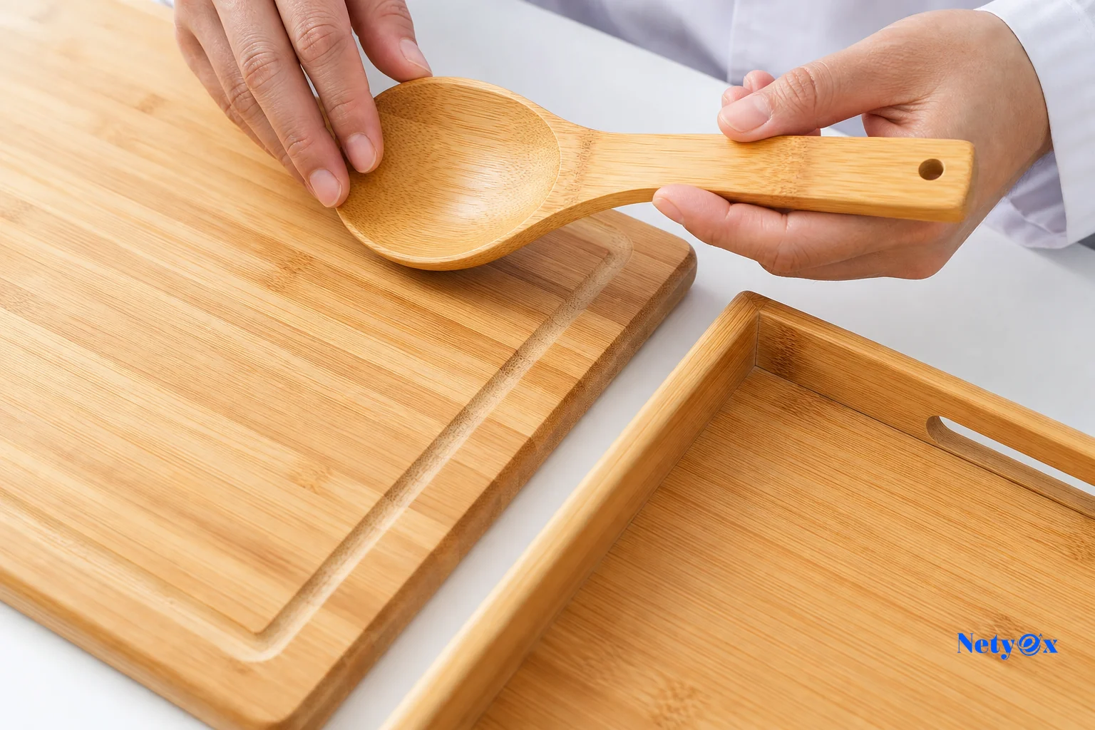 Close-up inspection of bamboo product samples showing grain texture, lacquer finish, and joint construction on a quality control table