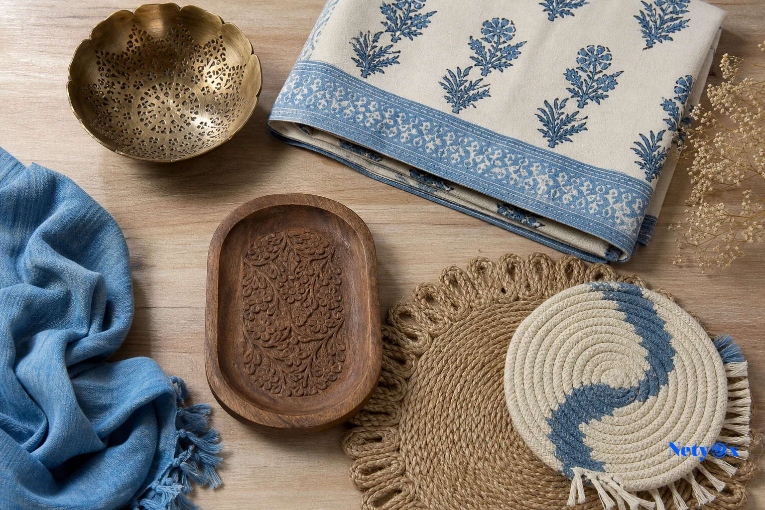 A curated flat-lay style display of Indian handicraft and textile products relevant to French home décor retailers. Photorealistic overhead flat-lay photograph of an assortment of Indian handicraft and home décor products arranged neatly on