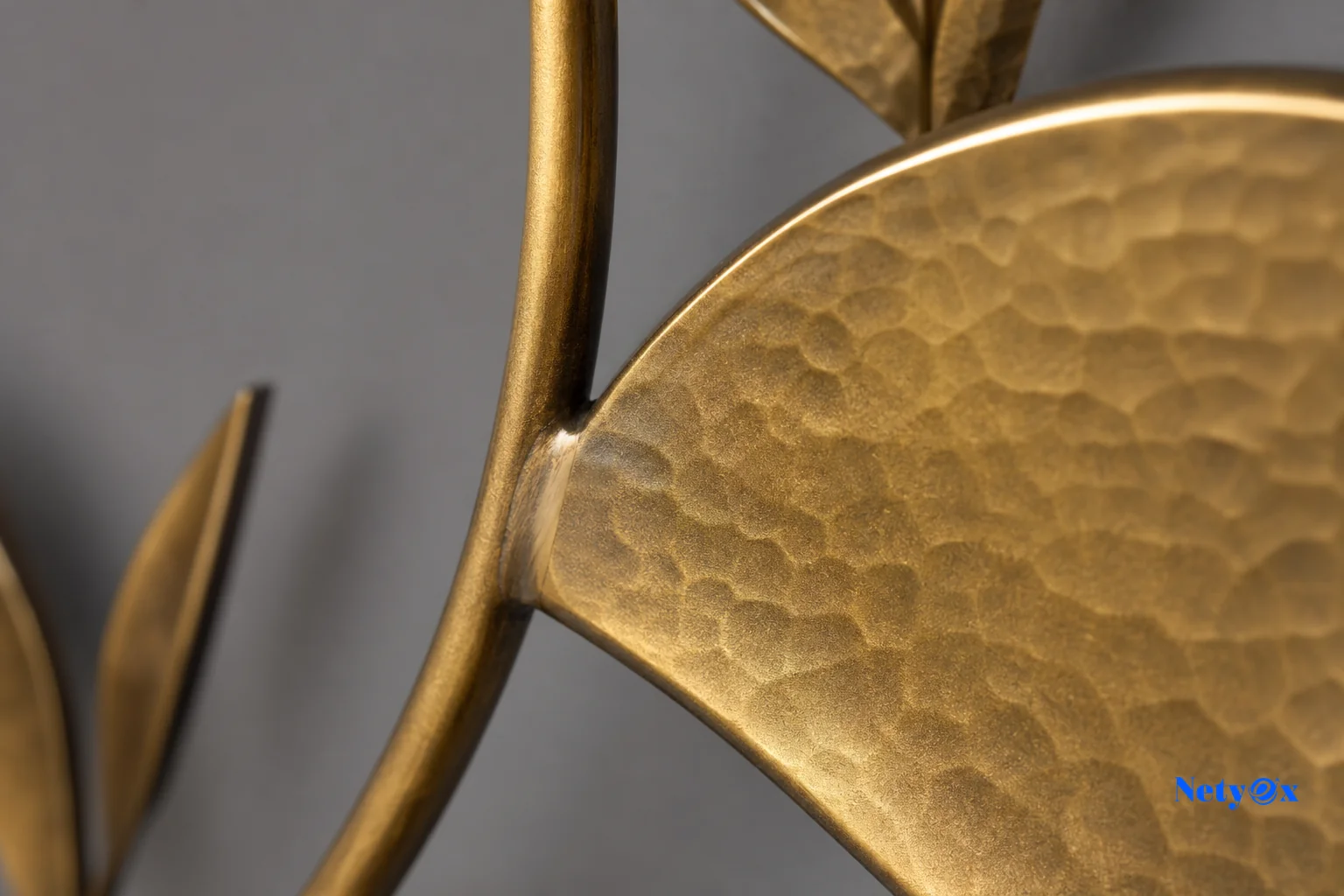 Quality inspector checking finish and weld consistency on metal wall art before export packaging